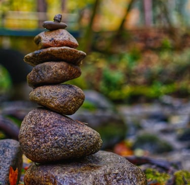 a stack of rocks sitting on top of a pile of leaves taken by Jordan Boyle of JJ Everitt Photography