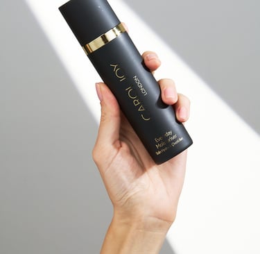 A woman's hand holding Carol Joy London Everyday Moisturiser