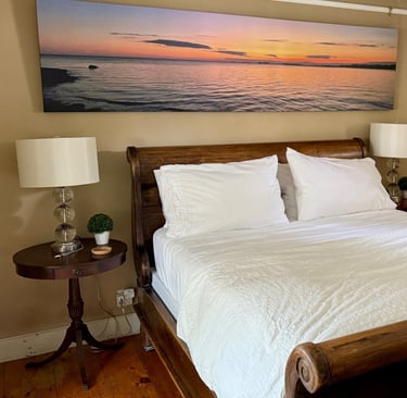 2nd ensuite bedroom with romantic sleigh bed and large-scale original canvas photography