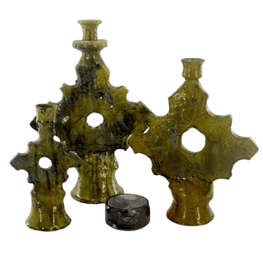 a group of three vases with a candle holder