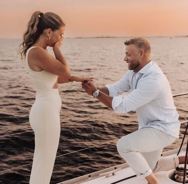 a man and woman on a boat in the ocean proposal 