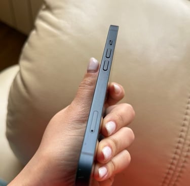 a person holding a cell phone in their hand