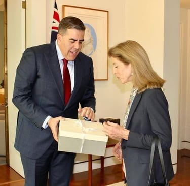 2 people one person handing a box to the other person