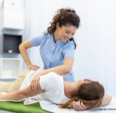 a woman treating patient through chiropractic