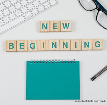 a keyboard and a notebook with a notepad and pen