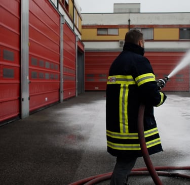 a firefighter in a fire hydrant spraying cafs foam