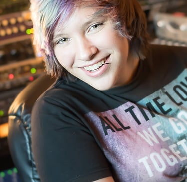 a woman with a colorful hair and a black shirt