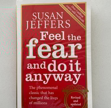 a book cover of a book with a red cover Feel the fear and do it anyway