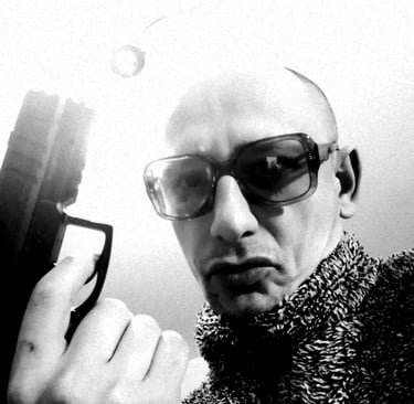a man in a sweater and sunglasses holding a gun