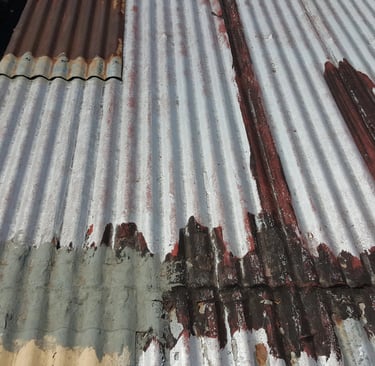 Advanced corrosion and material failure on metal roofing, example of roof beyond repair stage