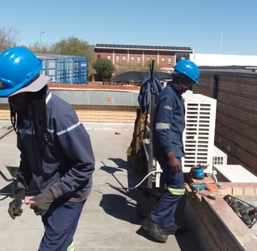 EPC roof repair team preparing surface on commercial flat roof in Bloemfontein