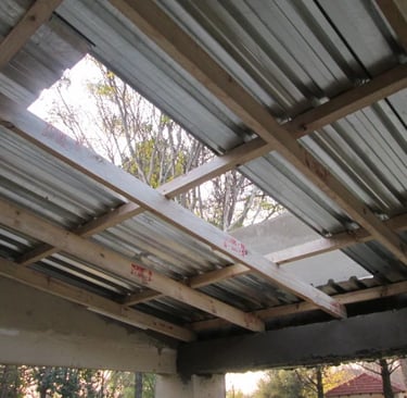 Metal sheet installation over compliant timber purlins