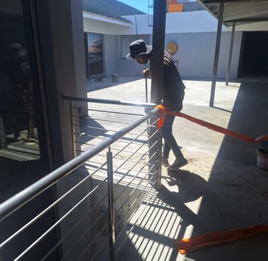 Ensuring clearing of fine debris after waterproof screed application, Harbor Bay Mall, Cape Town