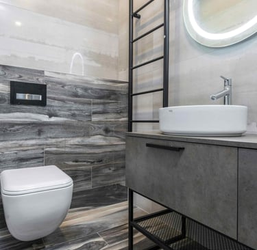 Modern grey-tiled bathroom with floating vanity