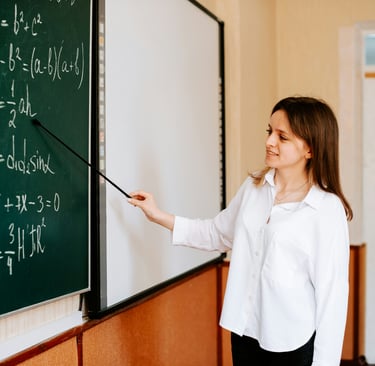 A Level Maths Online Tutoring students studing A Level Maths with a black board