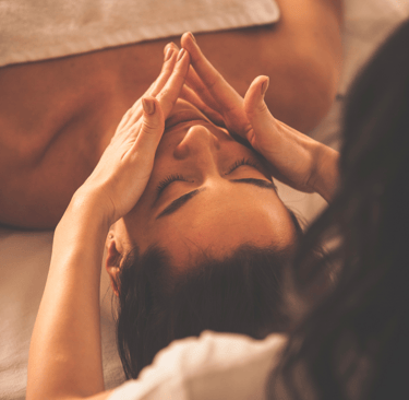 a woman having a facial massage in a beauty salon