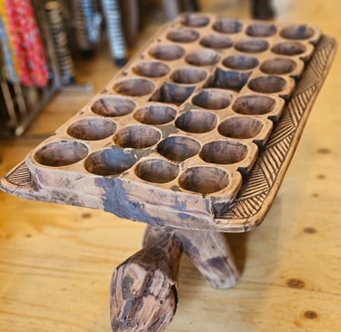 a giant wooden board game with with holes old ancient game with a shape of a turtle