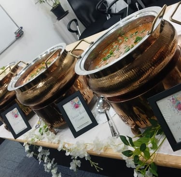 Corporate bufet catering service featuring copper chafing dishes with chicken handi,