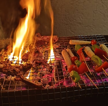 a grill with meat and vegetables on a grill