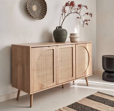 a wooden bamboo rattan cabinet with a vase with flowers