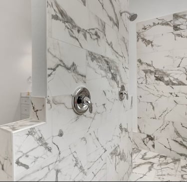 Luxurious double-headed shower in primary bathroom of custom home