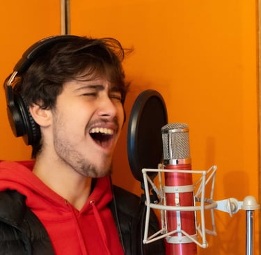Joseph Stidworthy singing into microphone at Vox Music Recording Studio in South Manchester