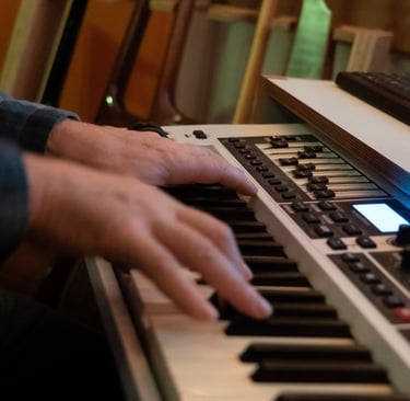 Luke Stidworthy playing keyboard at Vox Music Recording Studio in South Manchester