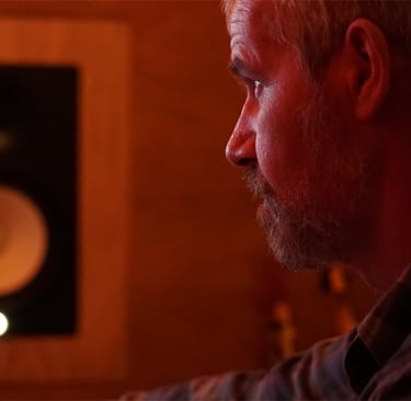 Luke Stidworthy staring at monitor at Vox Music Recording Studio in South Manchester