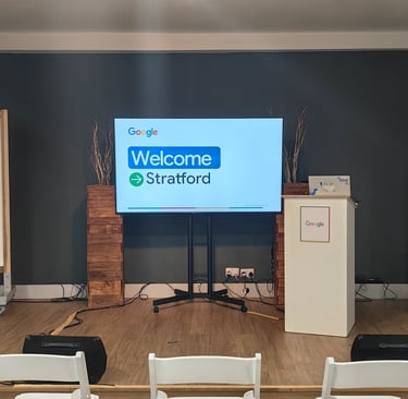 Welcome to Stratford displayed on TV screen in front of the room