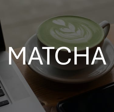 Photo of cup of matcha latte, darkened to contrast against white text overlay that says 'MATCHA'