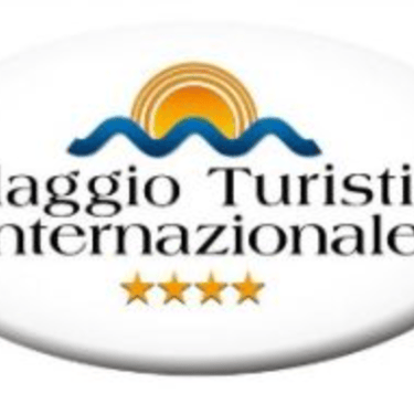 a white button with the words villaggio turistico international