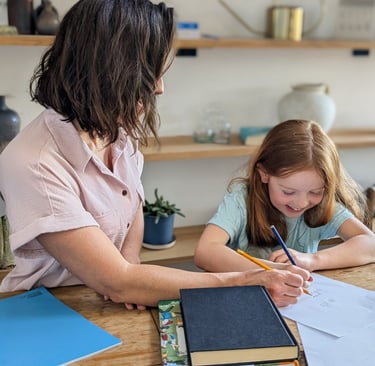 A mother helping her young daughter with 11+ preparation work trying to get ready for the test.