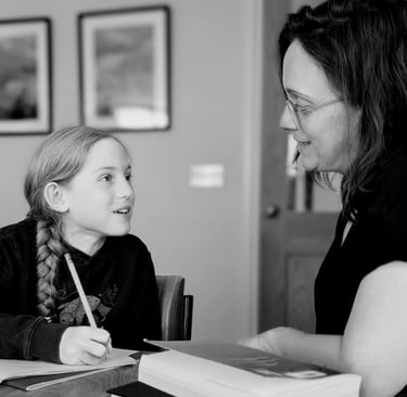 A primary school girl smiles at her teacher during a private tutoring session for Key stage 2 11+
