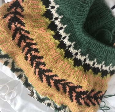 A knitted sweater sample with fair isle stitch pattern. It is handknitted