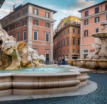 a fountain with a fountain in the middle of a courtyard