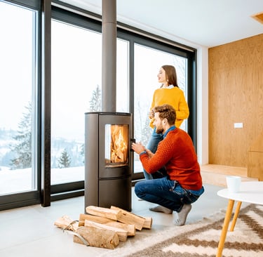 a man and woman sitting on a chair in a living room