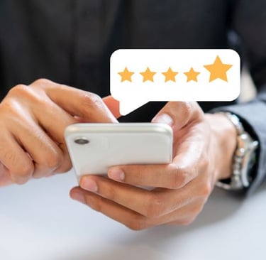 a man holding a cell phone with five stars on it