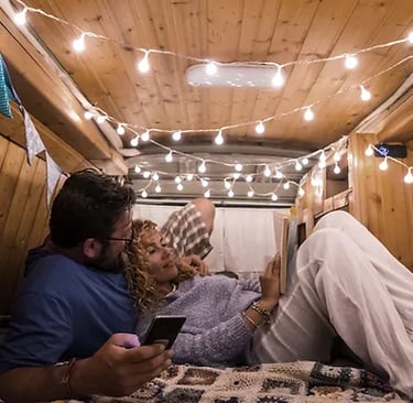 cute couple inside a small camper