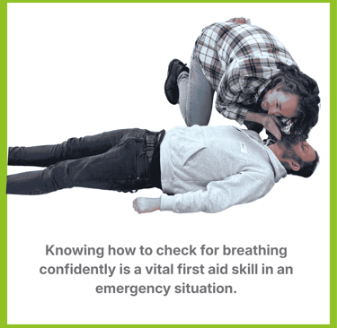 A man knelt over another man with his ear close to his face. He is listening for breathing.