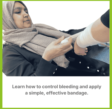 A woman in a headscarf bandaging learning the techniques of bandaging.