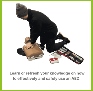 a student learning CPR on a manikin with an AED attached to the chest