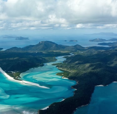 Aerial view of Hill Inlet and Whitehaven Beach with turquoise water and swirling white sands.