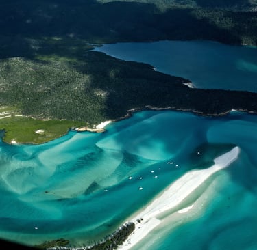 Aerial view of Hill Inlet and Whitehaven Beach with turquoise water and swirling white sand.
