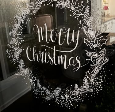 Photographic studio with hand drawn artwork on windows.  Seasonal window art by the letter Jo