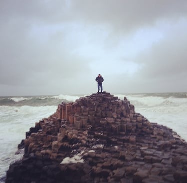 A man stood on Giant's Causeway, Ireland