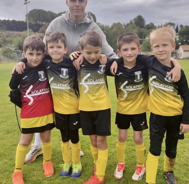 a man standing next to a group of young boys