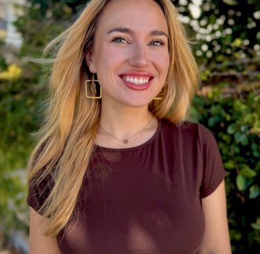 owner of business headshot in front of greenery