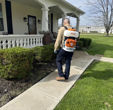 Pest control technician servicing for mosquitoes and ticks