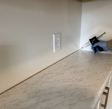 Ant gel bait being applied on kitchen counter top