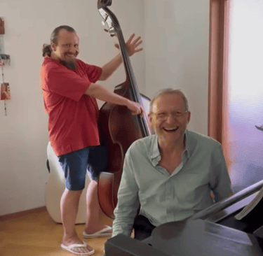 a man playing a bass and a man playing the piano